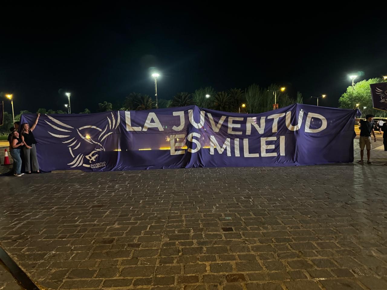 Bandera de la Juventud con el lema La Juventud es Milei, de noche